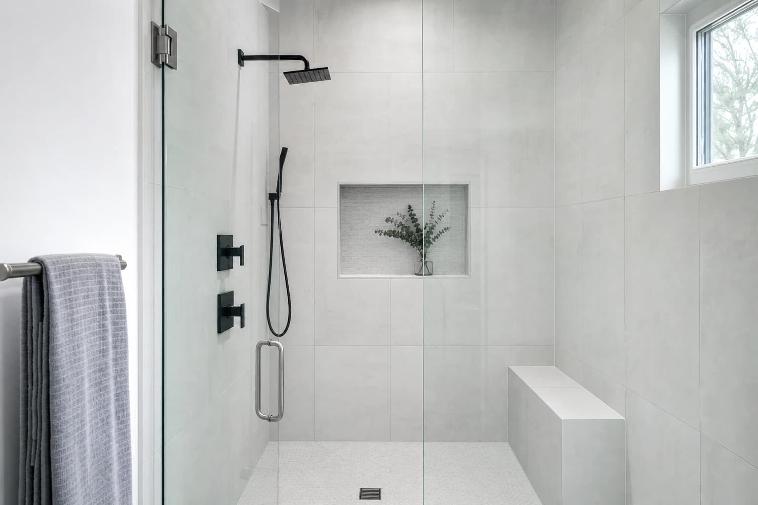 Walk-in tile shower with grey porcelain and frameless glass in a Sacramento bathroom remodel